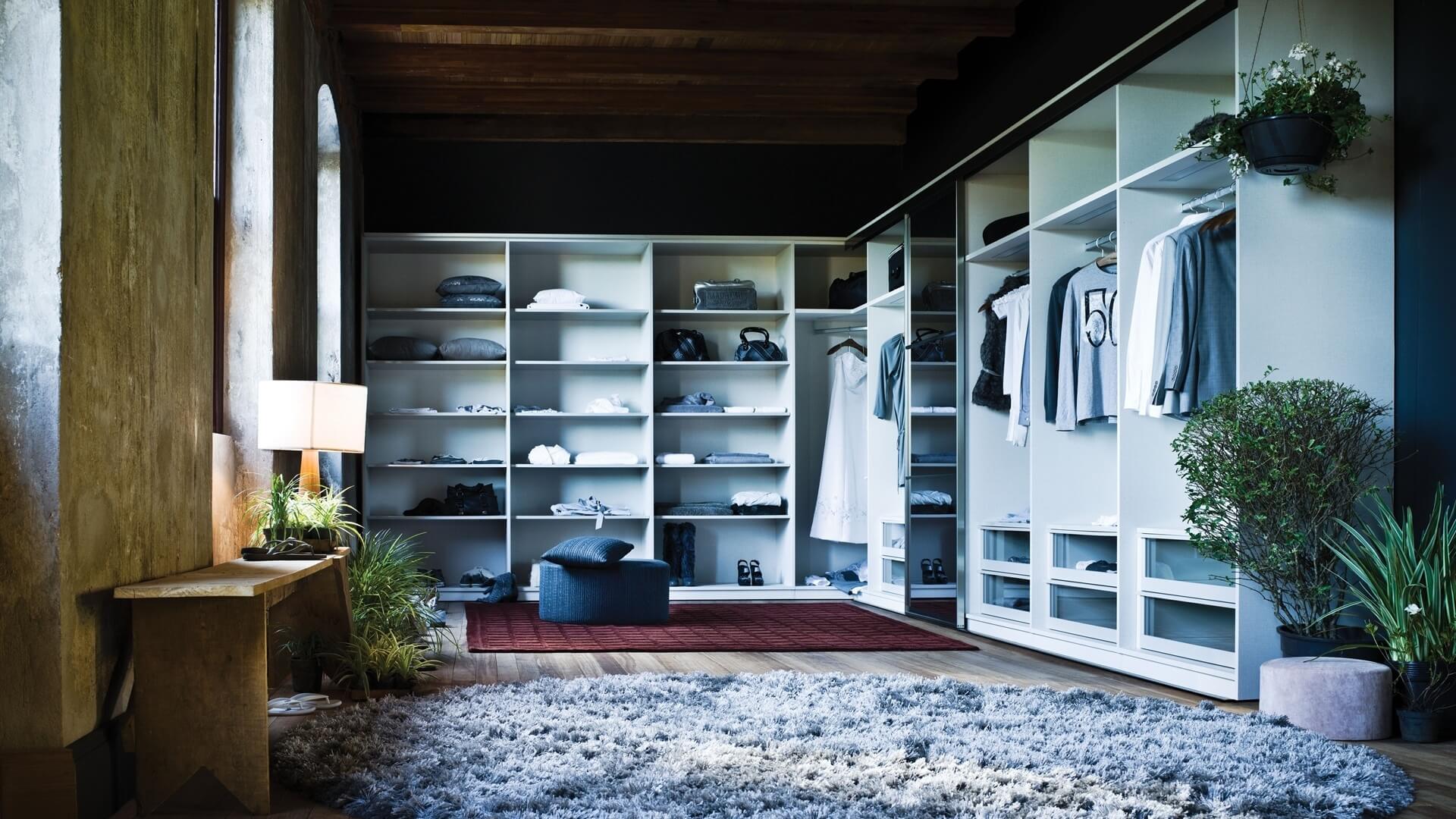A spacious, elegant closet space with dark accents